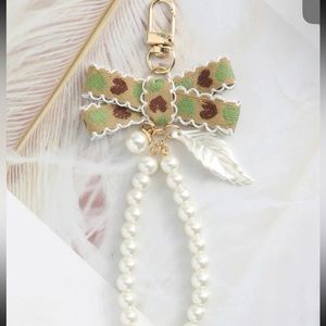 3/$25 GORGEOUS FAUX PEARL WITH BOW BAG CHARM.